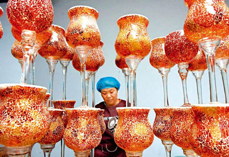 2017年6月27日，在山东省沂源县历山街道彩板峪村一玻璃制品企业，工人在检验准备出口俄罗斯的玻璃瓶。（新华社供图）